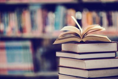 book-in-library-with-open-textbook