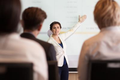 serious-businesswoman-showing-table-to-audience