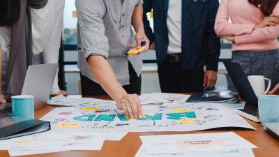 happy-young-asian-businessmen-and-businesswomen-meeting-brainstorming-ideas-about-new-paperwork-project