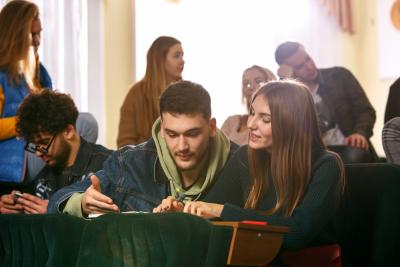 the-group-of-cheerful-happy-students-sitting-in-lecture-hall-before-lesson